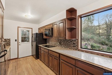 A custom chalet-style home surrounded by natural forest on - photo 24