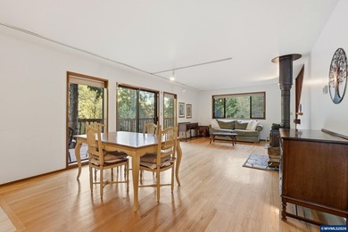 A custom chalet-style home surrounded by natural forest on - photo 26