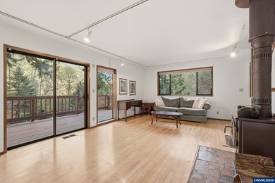 A custom chalet-style home surrounded by natural forest on - photo 27