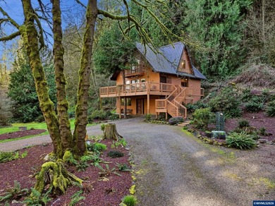 A custom chalet-style home surrounded by natural forest on - photo 40