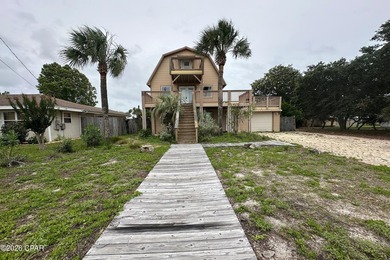 This three-story elevated beach house features 4 bedrooms, 3 - photo 1