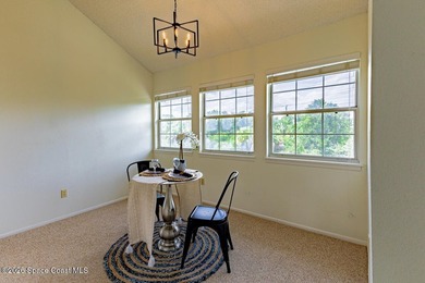 This two-story condo has high vaulted ceilings, skylights, and a - photo 11