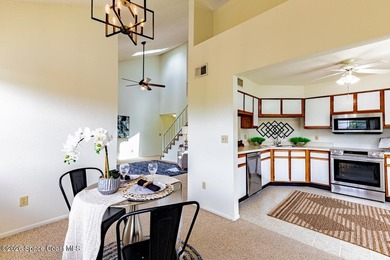 This two-story condo has high vaulted ceilings, skylights, and a - photo 12