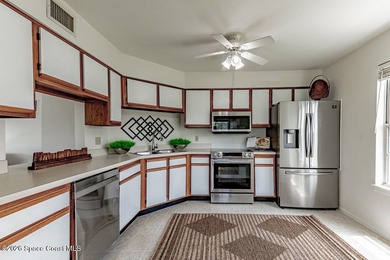 This two-story condo has high vaulted ceilings, skylights, and a - photo 14