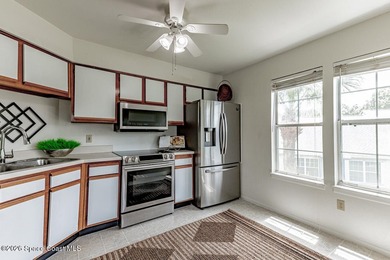This two-story condo has high vaulted ceilings, skylights, and a - photo 15