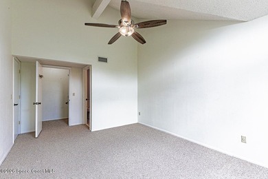This two-story condo has high vaulted ceilings, skylights, and a - photo 23