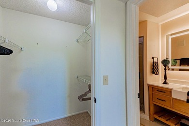 This two-story condo has high vaulted ceilings, skylights, and a - photo 24
