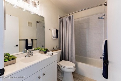 This two-story condo has high vaulted ceilings, skylights, and a - photo 31