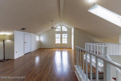 This two-story condo has high vaulted ceilings, skylights, and a - photo 35