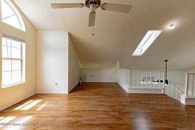 This two-story condo has high vaulted ceilings, skylights, and a - photo 36