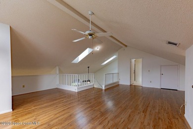 This two-story condo has high vaulted ceilings, skylights, and a - photo 37