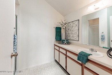 This two-story condo has high vaulted ceilings, skylights, and a - photo 38