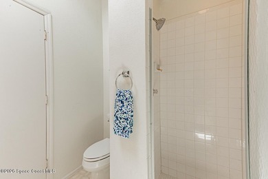 This two-story condo has high vaulted ceilings, skylights, and a - photo 39