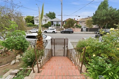 This well-cared for triplex is perched above the street and is - photo 3
