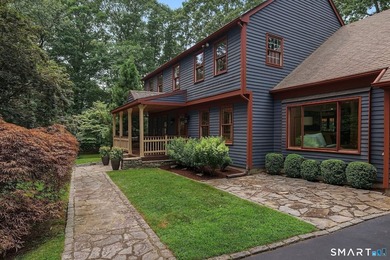 Set gracefully on a beautifully landscaped property framed by - photo 2
