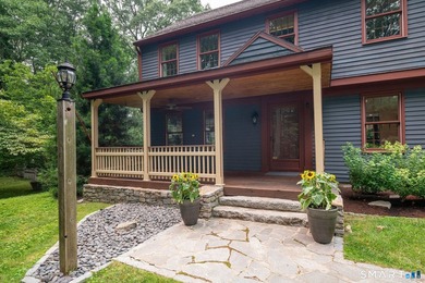 Set gracefully on a beautifully landscaped property framed by - photo 3