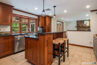 Set gracefully on a beautifully landscaped property framed by - photo 10