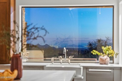 Framed by sweeping views of Pinnacle Peak and city lights, this