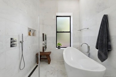A fully renovated two-family townhouse spanning approximately 3 - photo 11