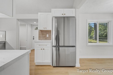 Enjoy views of Bostwick Lake from this completely updated home - photo 11