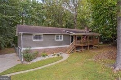 Nestled on a level lot just over half an acre, this beautifully - photo 2