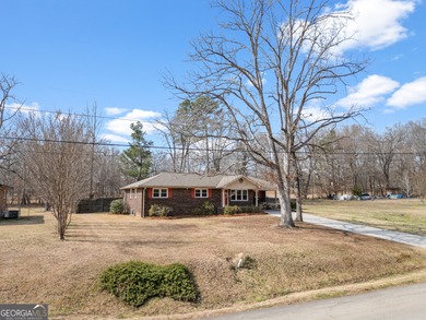 This four-sided brick, one-level home offers 3 bedrooms and 1.5