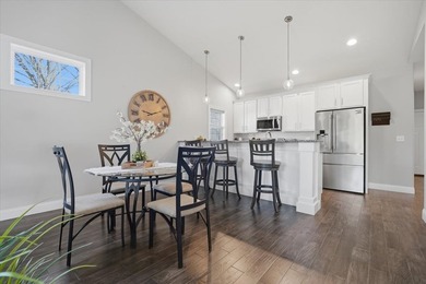 Gorgeous zero-lot home with wood flooring throughout main level