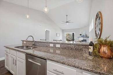 Gorgeous zero-lot home with wood flooring throughout main level