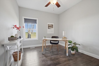 Gorgeous zero-lot home with wood flooring throughout main level