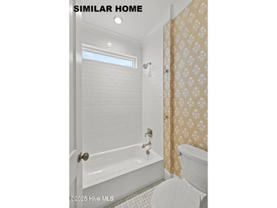 Discover unparalleled coastal living at 607a S Topsail Drive