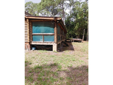 This 2-bedroom, 2-bathroom log cabin offers rustic charm. It is - photo 12