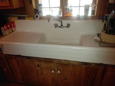 This 2-bedroom, 2-bathroom log cabin offers rustic charm. It is - photo 16