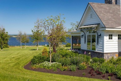A willow-lined drive creates a grand approach to this Grand Isle - photo 4