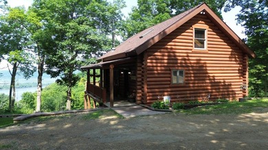 Escape to this cabin-style retreat with gorgeous river views and - photo 2