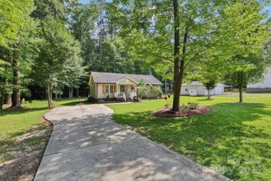 Nestled in the serene, gated community of Woodrun on Lake - Lake Home For Sale in Mount Gilead, North Carolina