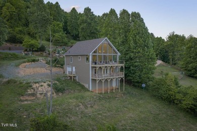 Perched above the crystal-clear waters of Watauga Lake, this - photo 6