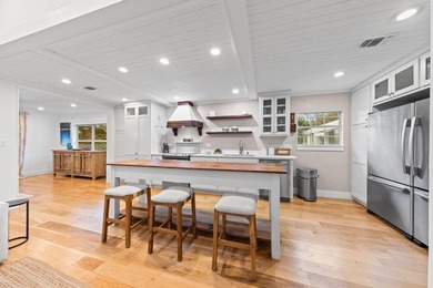 Discover a rare blend of coastal elegance and serene lakefront - photo 5