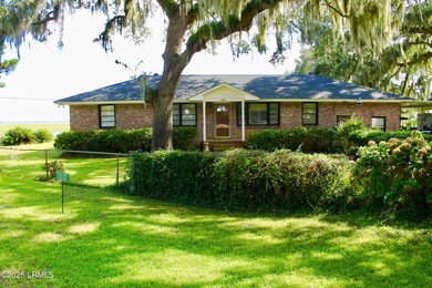 Tucked beneath a canopy of moss-draped live oaks, this home in - photo 3