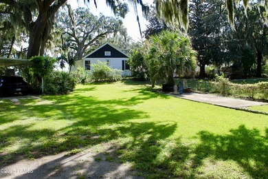 Tucked beneath a canopy of moss-draped live oaks, this home in - photo 4