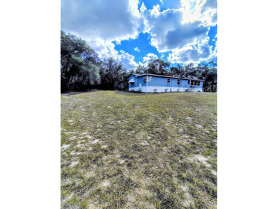 This charming 4-bedroom, 2-bath mobile home presents a fantastic - photo 4