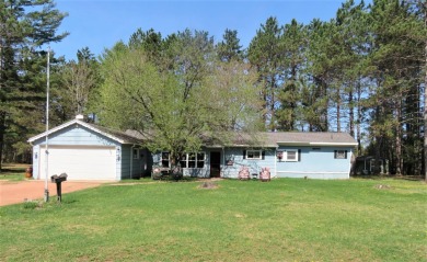 Close to the Moen Lake Chain & situated on approx. .80 acres of - Lake Home For Sale in R HI NE LA ND ER, Wisconsin