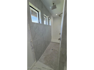 This stunning new construction features impact windows and doors - photo 13