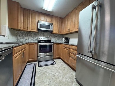This fully furnished ground floor condo has tile floor and - photo 5