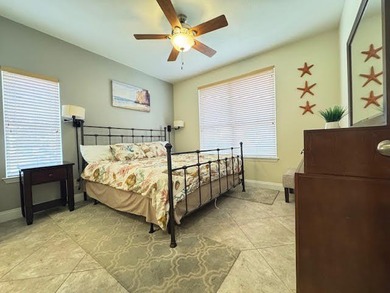 This fully furnished ground floor condo has tile floor and - photo 9