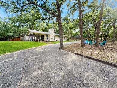 Tucked among the trees on a hillside lot in Tanglewood, this - photo 1