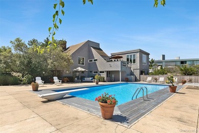 Set on 0.69 acres, bordering a two-acre dune preserve, this - photo 1