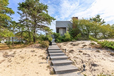 Set on 0.69 acres, bordering a two-acre dune preserve, this - photo 2