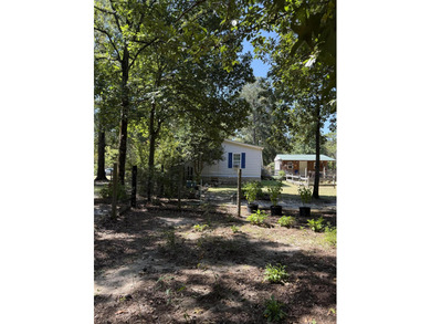 Welcome to 5+ private acres in New Ellenton! This spacious 3