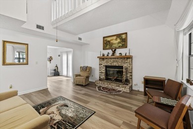 Lakefront home with a cozy living room with vaulted ceiling and - photo 7