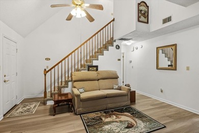 Lakefront home with a cozy living room with vaulted ceiling and - photo 9